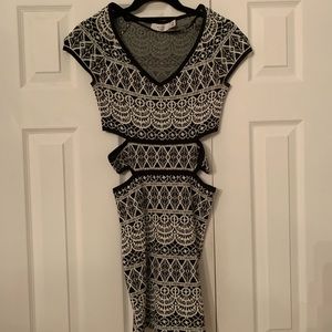 White and black pattern dress with cut out on the stomach.